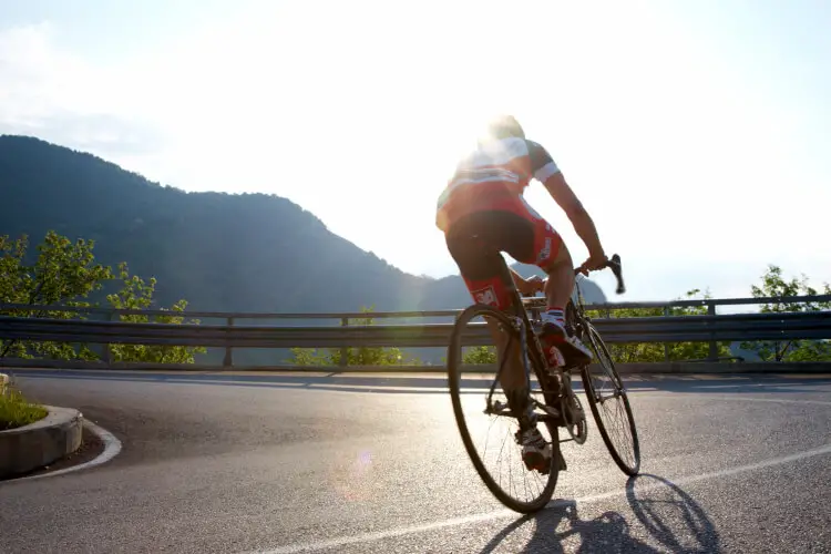Man riding road bike uphill