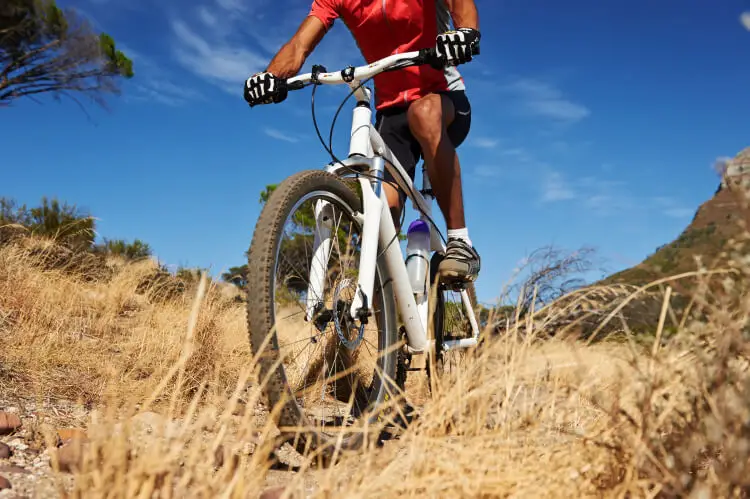 Trail bike riding with mountains in background